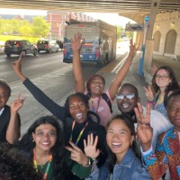 Group of students posing near Bus stop with happiness